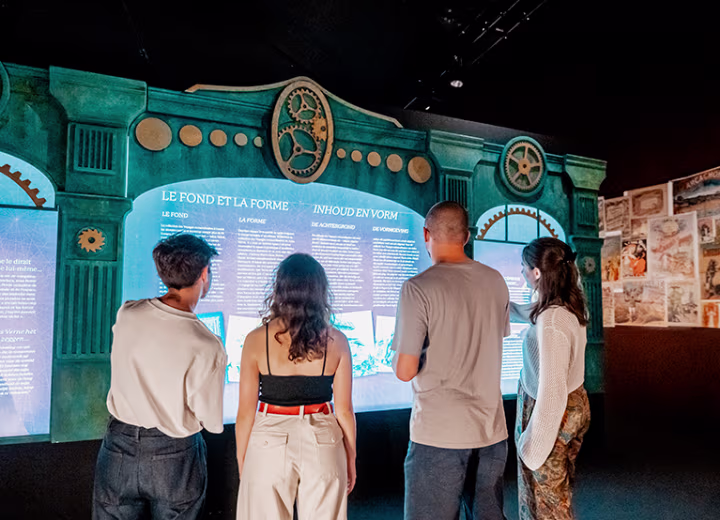 People reading at the immersive Jules Verne 200 exhibition in Brussels